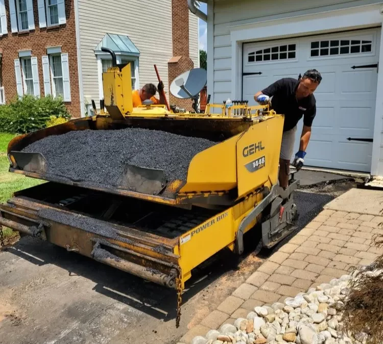 A man loading asphalt onto a machine.